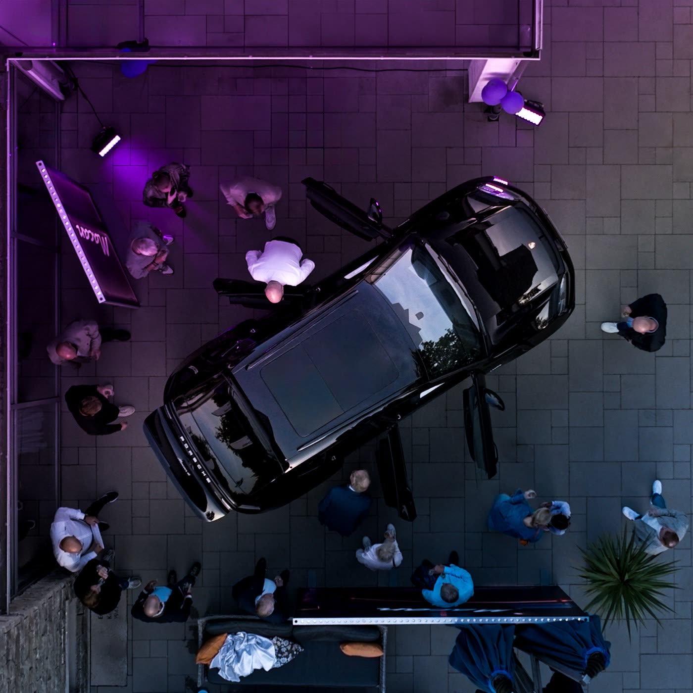 Porsche Macan Electric front wheel detail under purple lighting at dusk, Porsche Center Kalmar