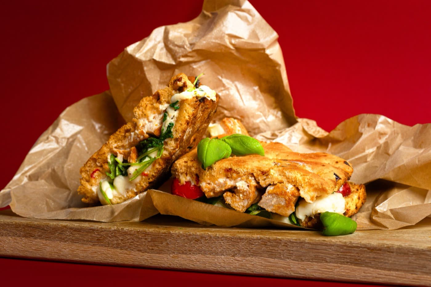 Blueberry soft-serve sundae with macaron in a glass cup on blue, Togo Kalmar